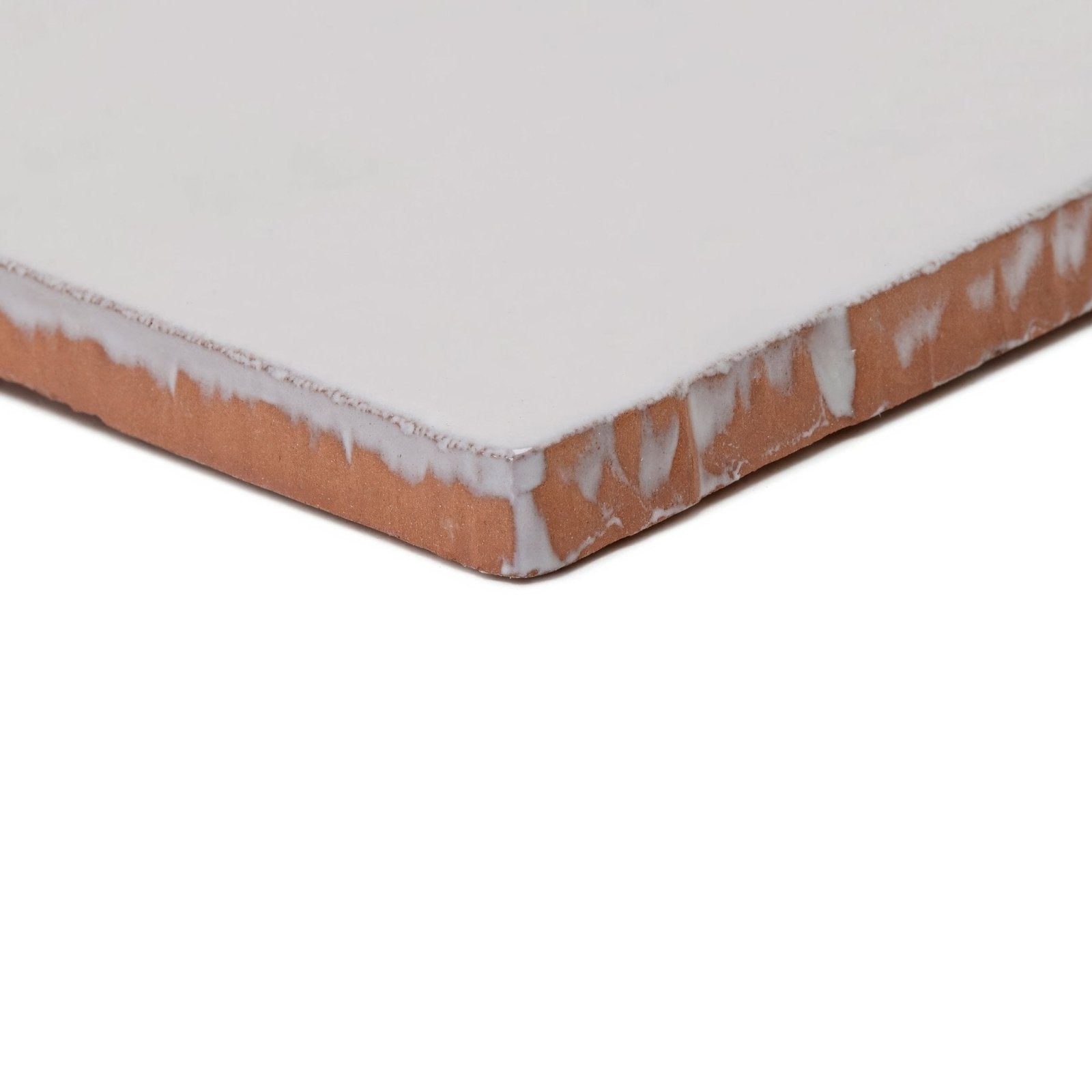 White ceramic forecast sky square glazed tile with rustic terracotta edge and chipped glaze detail