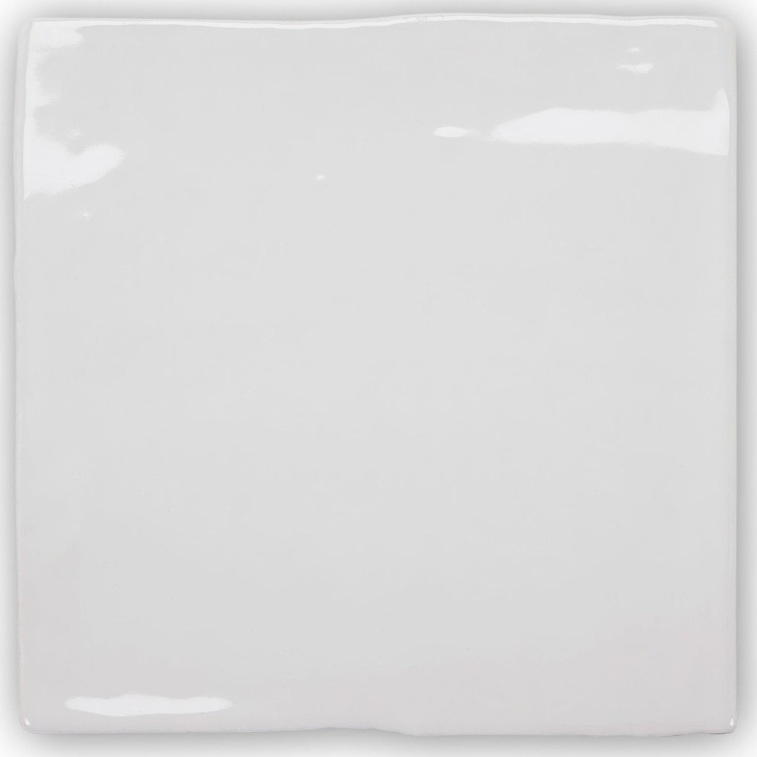 A glossy white ceramic forecast wight square glazed tile with slightly rounded edges and a smooth reflective surface
