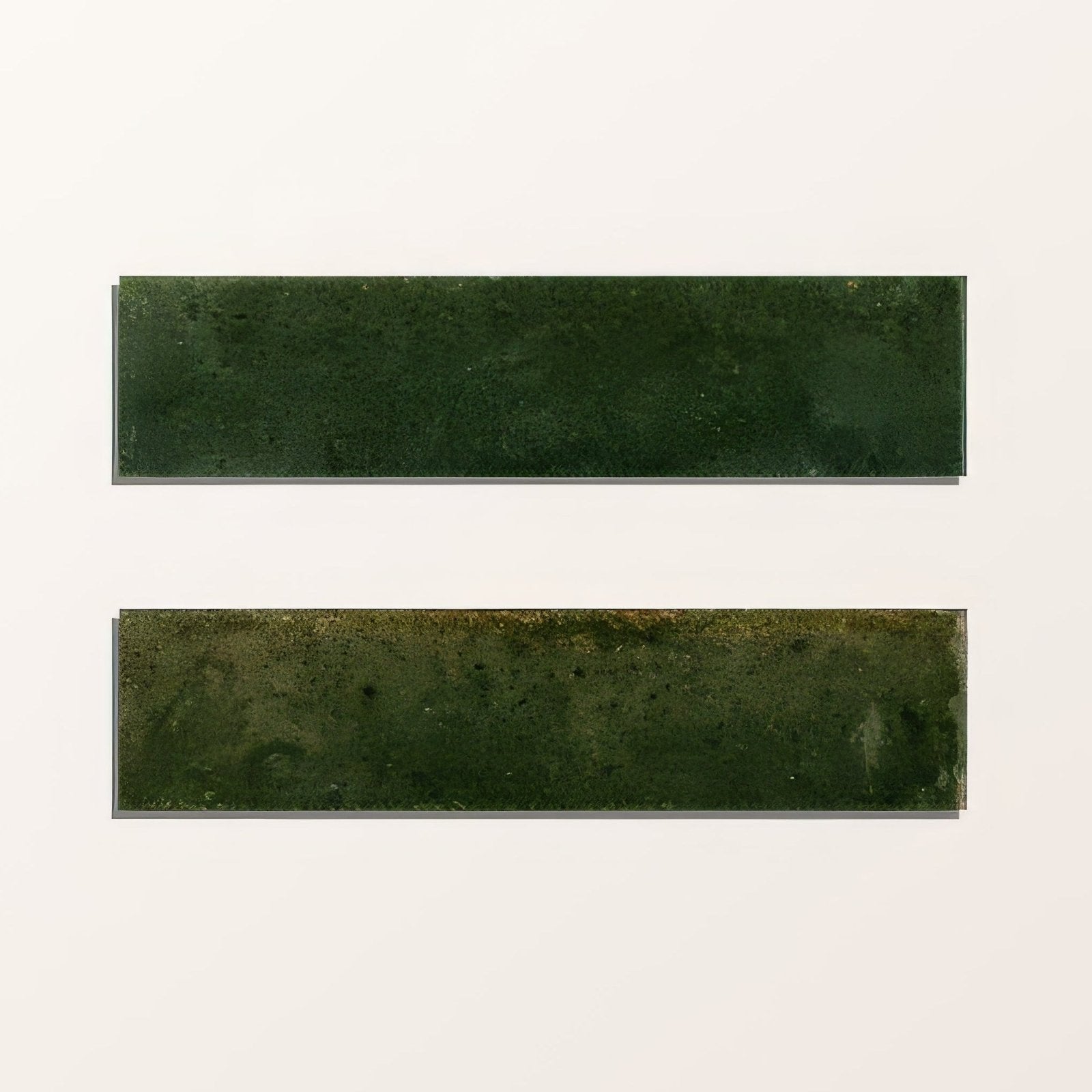 Two rectangular green porcelain alligator green tiles with matte textured surface and subtle shade variations