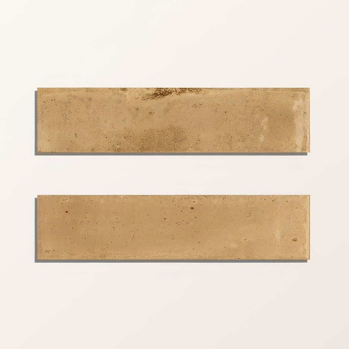 Two rectangular beige foundry novo porcelain tiles with textured stone-like surface and subtle tone variations