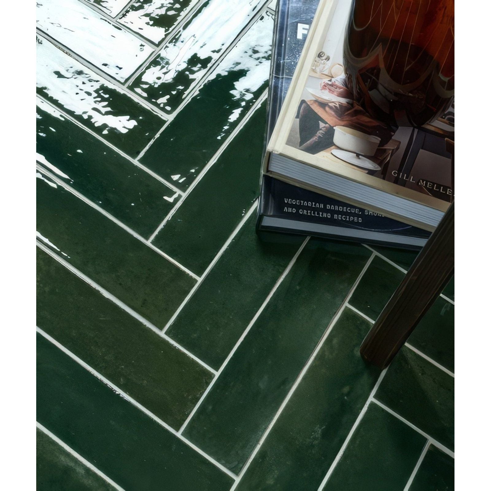 Deep green foundry novo porcelain tiles with glossy finish arranged in a herringbone pattern