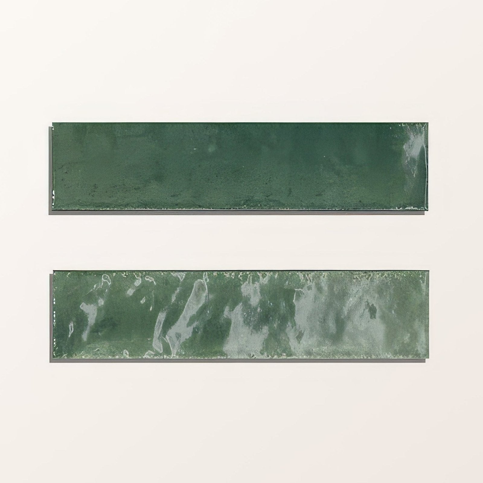 Two rectangular green ceramic tiles, one matte solid and one marbled, from foundry novo porcelain irish green collection