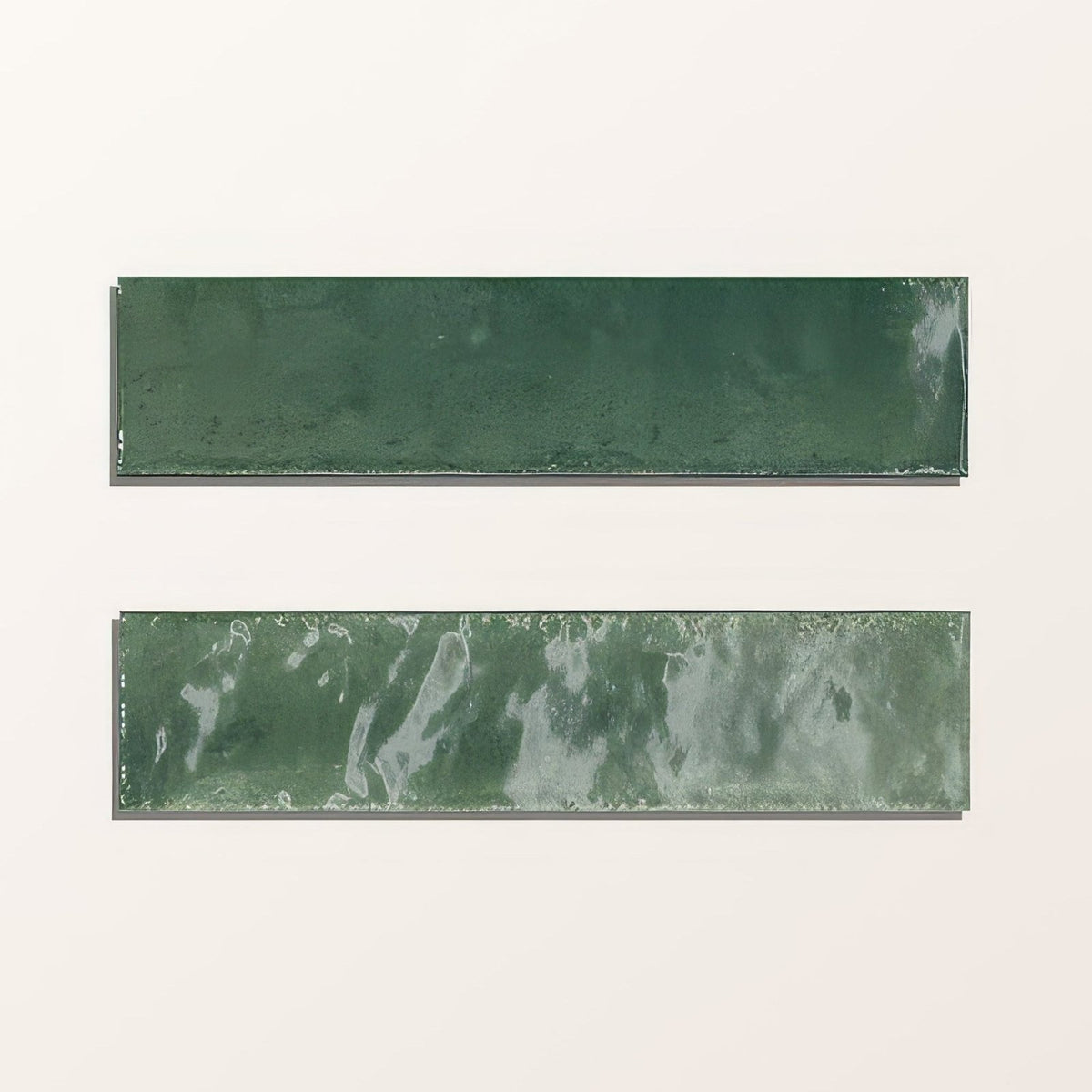 Two rectangular green ceramic tiles, one matte solid and one marbled, from foundry novo porcelain irish green collection
