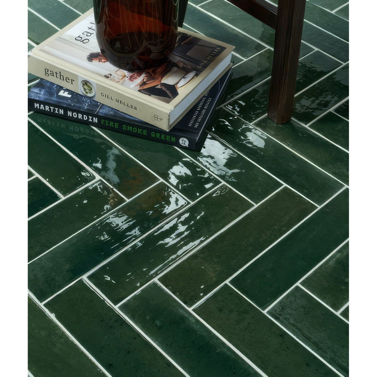 Foundry novo porcelain irish green dark green glossy rectangular tiles arranged in a herringbone pattern with white grout