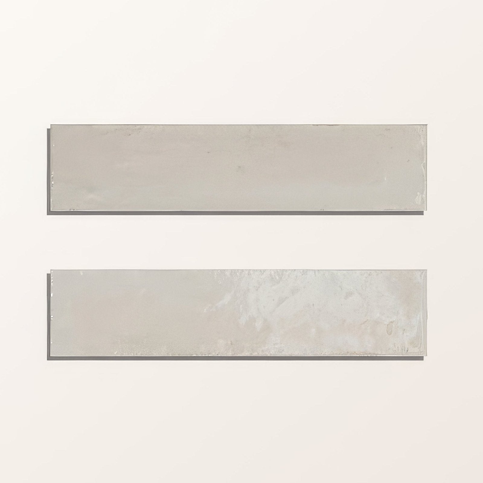 Two soft gray rectangular foundry novo porcelain linen tiles with matte finish and subtle texture variations
