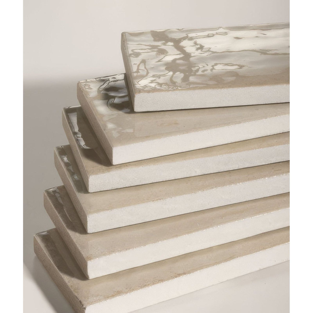Stack of foundry novo porcelain linen rectangular ceramic tiles with matte finish and subtle gray veining