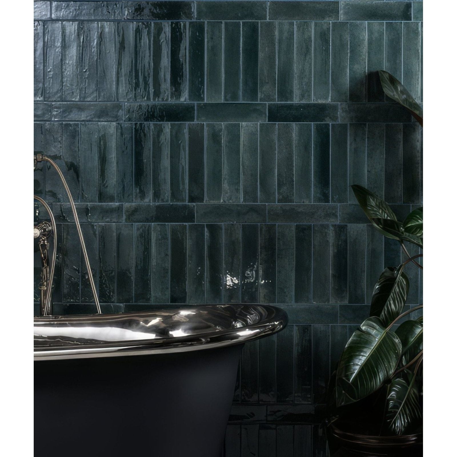 Foundry novo porcelain navy dark green glossy textured rectangular tiles behind black clawfoot bathtub wall panel