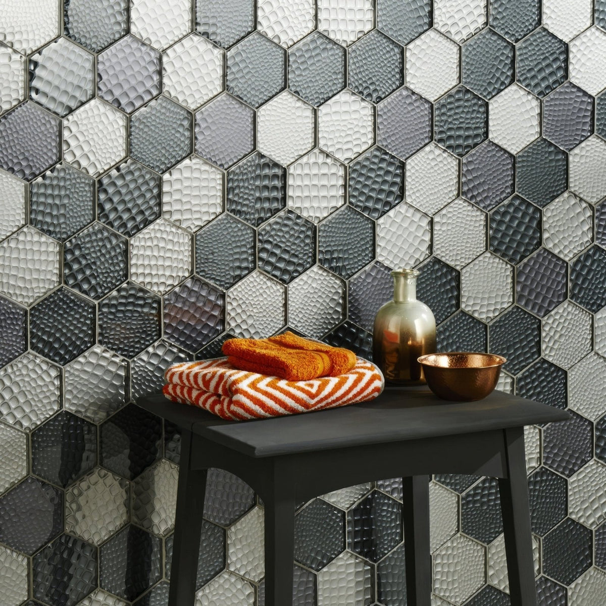 Futura Zirconia Hexagon Mosaic grey and white hexagon mosaic with a stack of orange striped towels