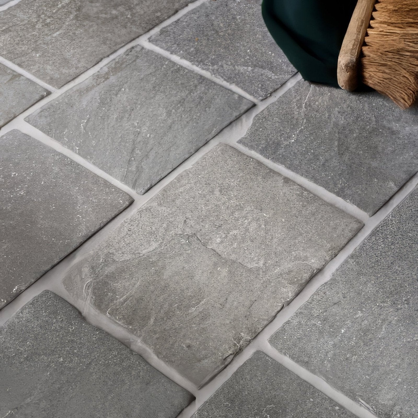 Gray stone-effect flooring tiles with subtle texture and white grout lines galway limestone cobble seasoned finish