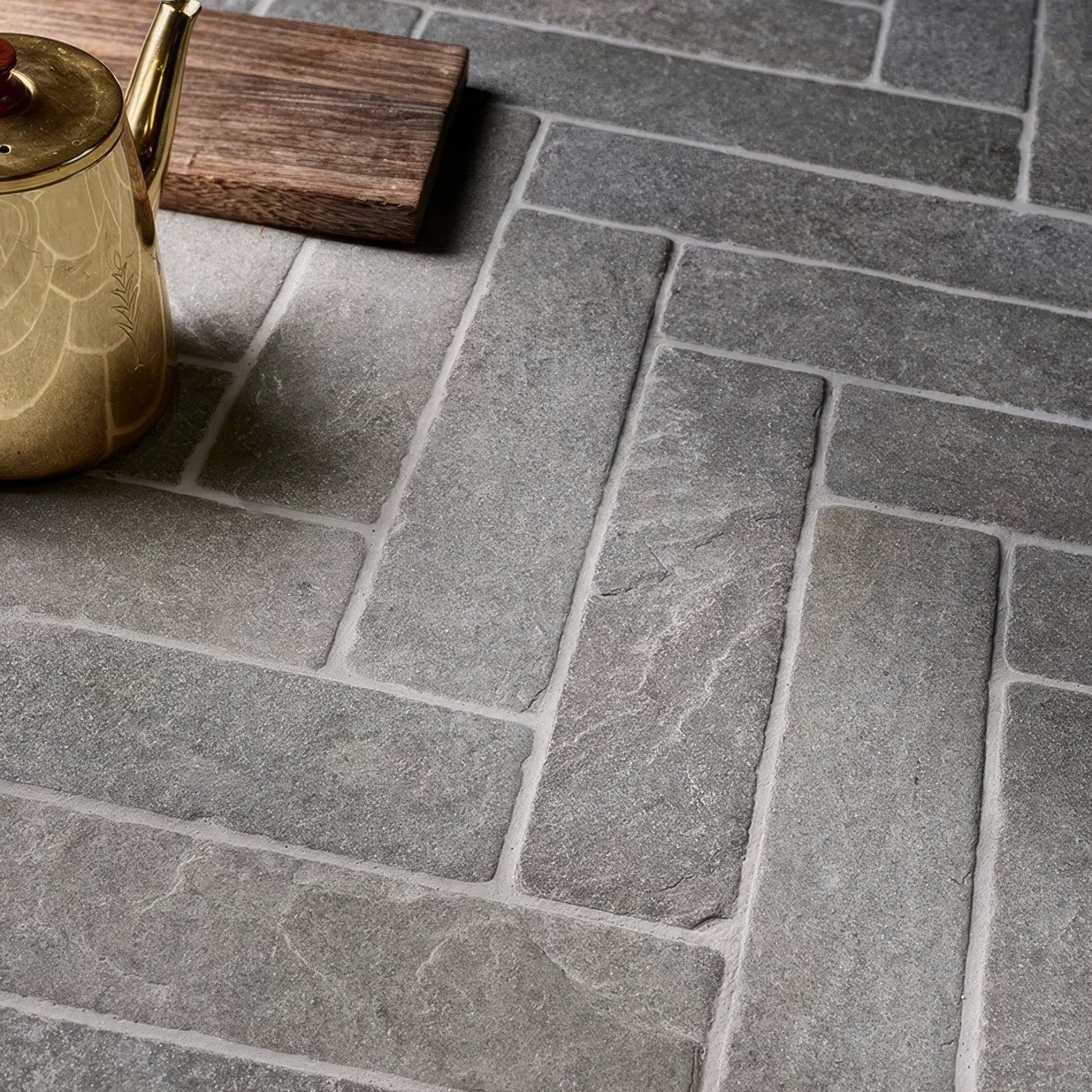 Gray galway limestone seasoned parquet stone tiles arranged in a herringbone pattern for flooring use
