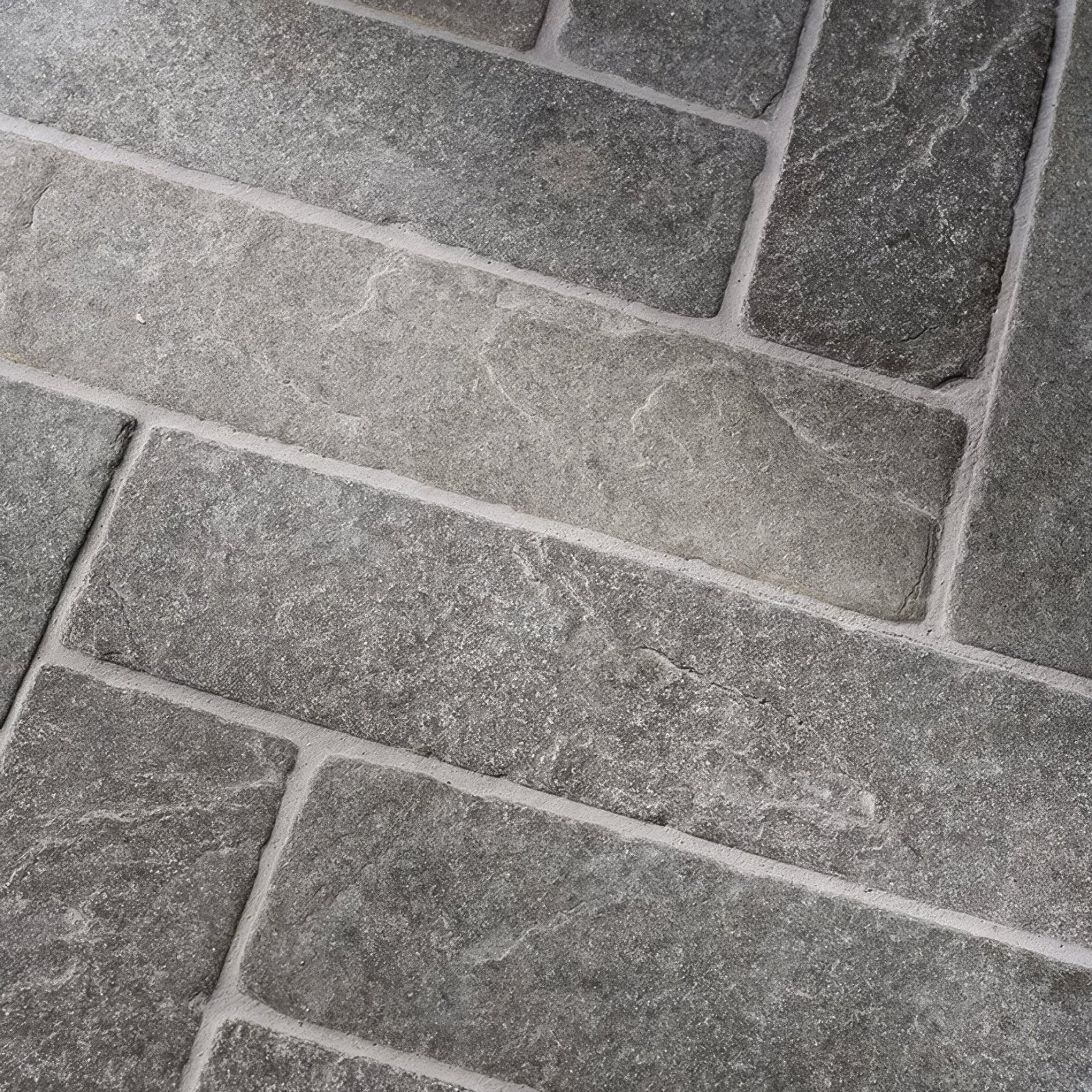 Gray stone tiles with rough textured surface and natural veining in galway limestone seasoned parquet flooring