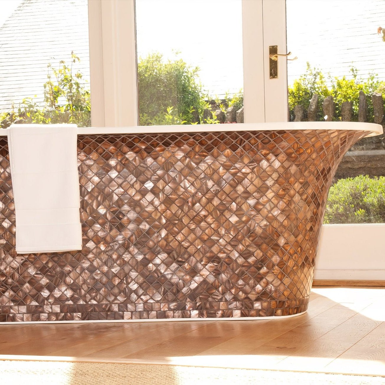 Gentle Earth 25mm Square copper-toned diamond mosaic on a freestanding bathtub