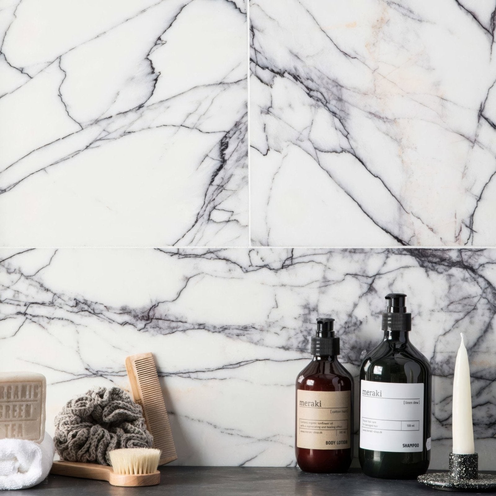 Georgica Pond Diamond Sawn Edge Polished white marble tiles with dark glass pump bottles on a countertop