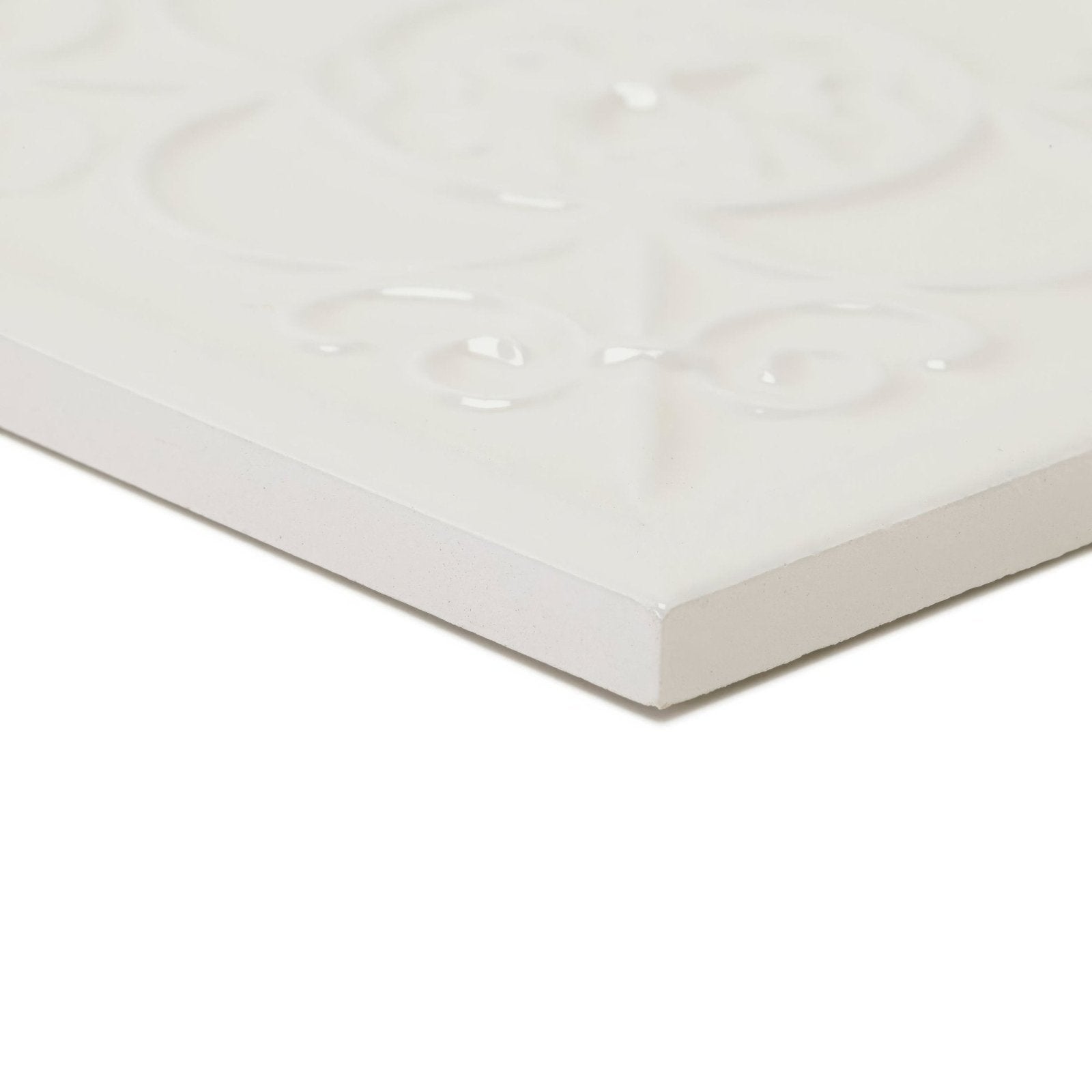 White ceramic tile with raised ornate floral embossing in cream color giralda cascara cream decor tile