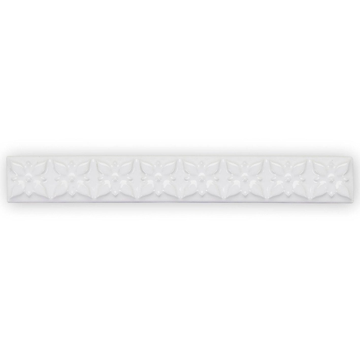 White ceramic tile giralda hielo white trim with a repeating embossed floral pattern for decorative wall use