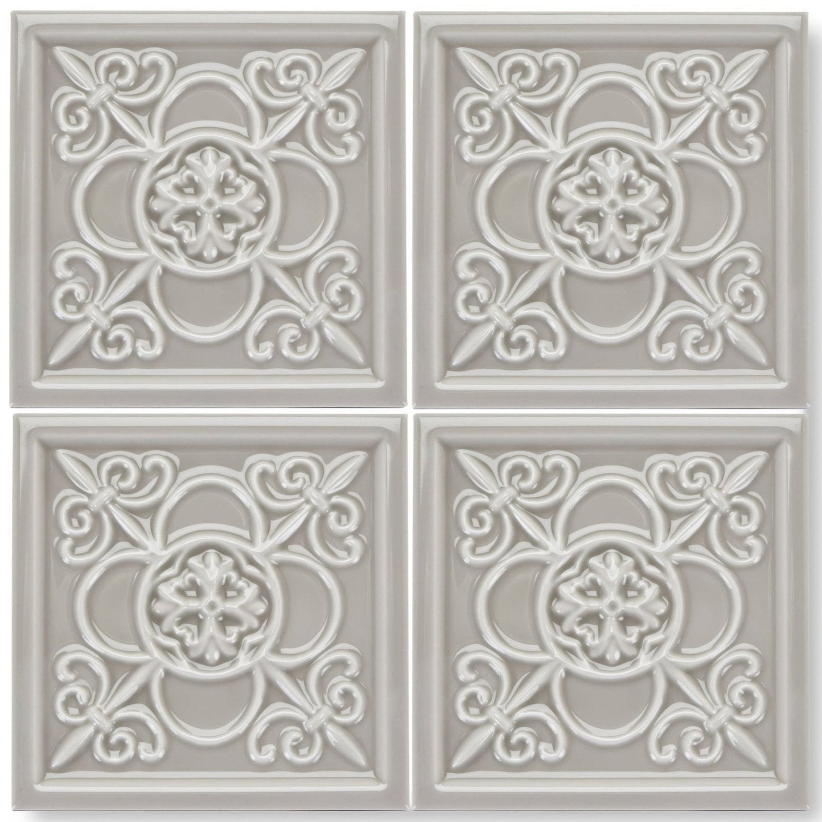 Set of four light gray ceramic giralda niebla grey decor tiles with raised ornate floral and scrollwork patterns