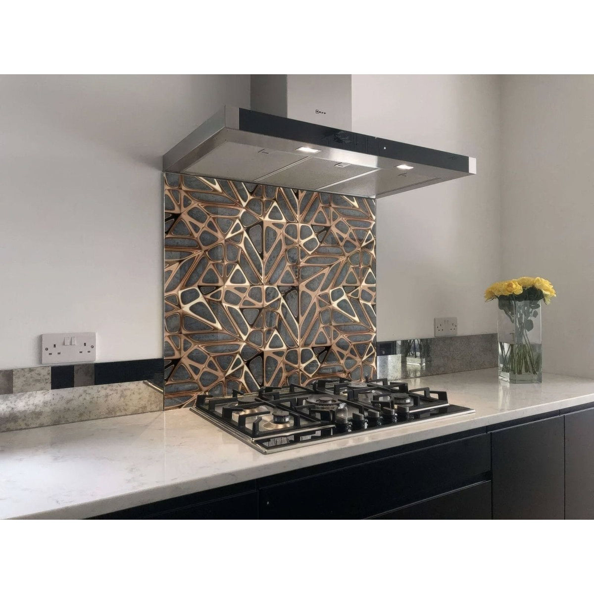 Geometric-patterned copper and black glass kitchen backsplash featured on a gold copper lattice grid concrete shower panel