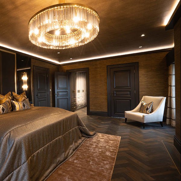 A luxurious circular chandelier with cascading crystal strands and warm glowing lights in goodrich charred oak design