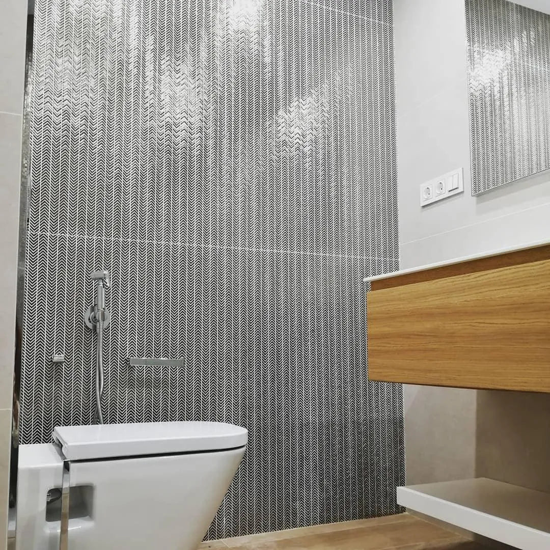 Modern white ceramic toilet with sleek minimalist design and chrome flush handle featured with gravity aluminium arrow metal mosaic