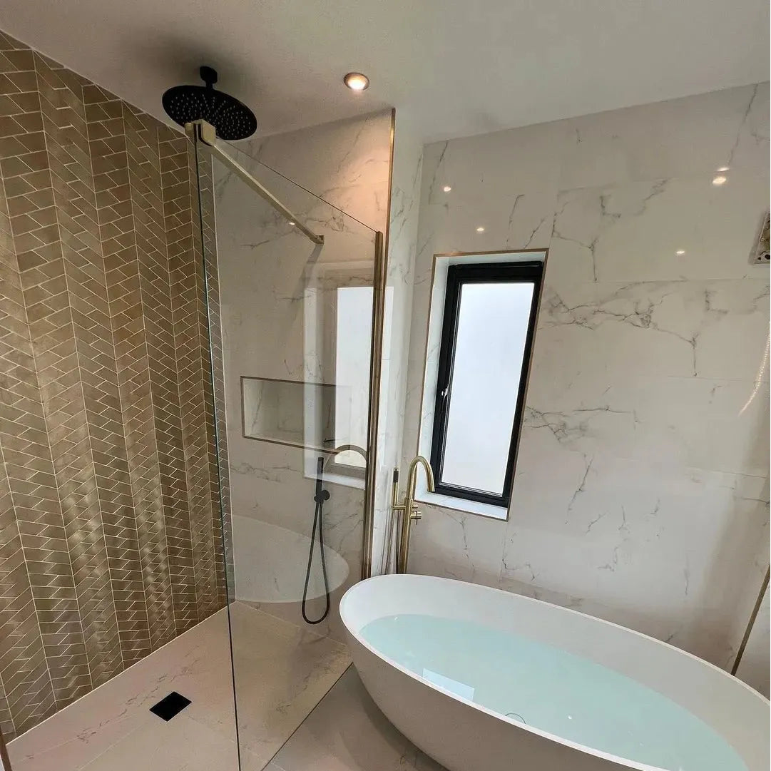 Gravity Aluminium Trace Gold Mosaic gold chevron aluminium mosaic with a white freestanding bathtub