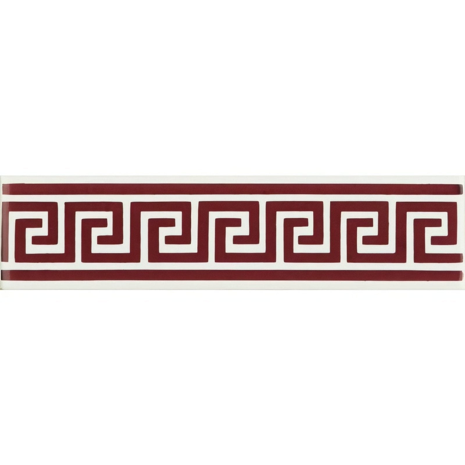 A rectangular ceramic tile with a bold red greek key pattern on a brilliant white background