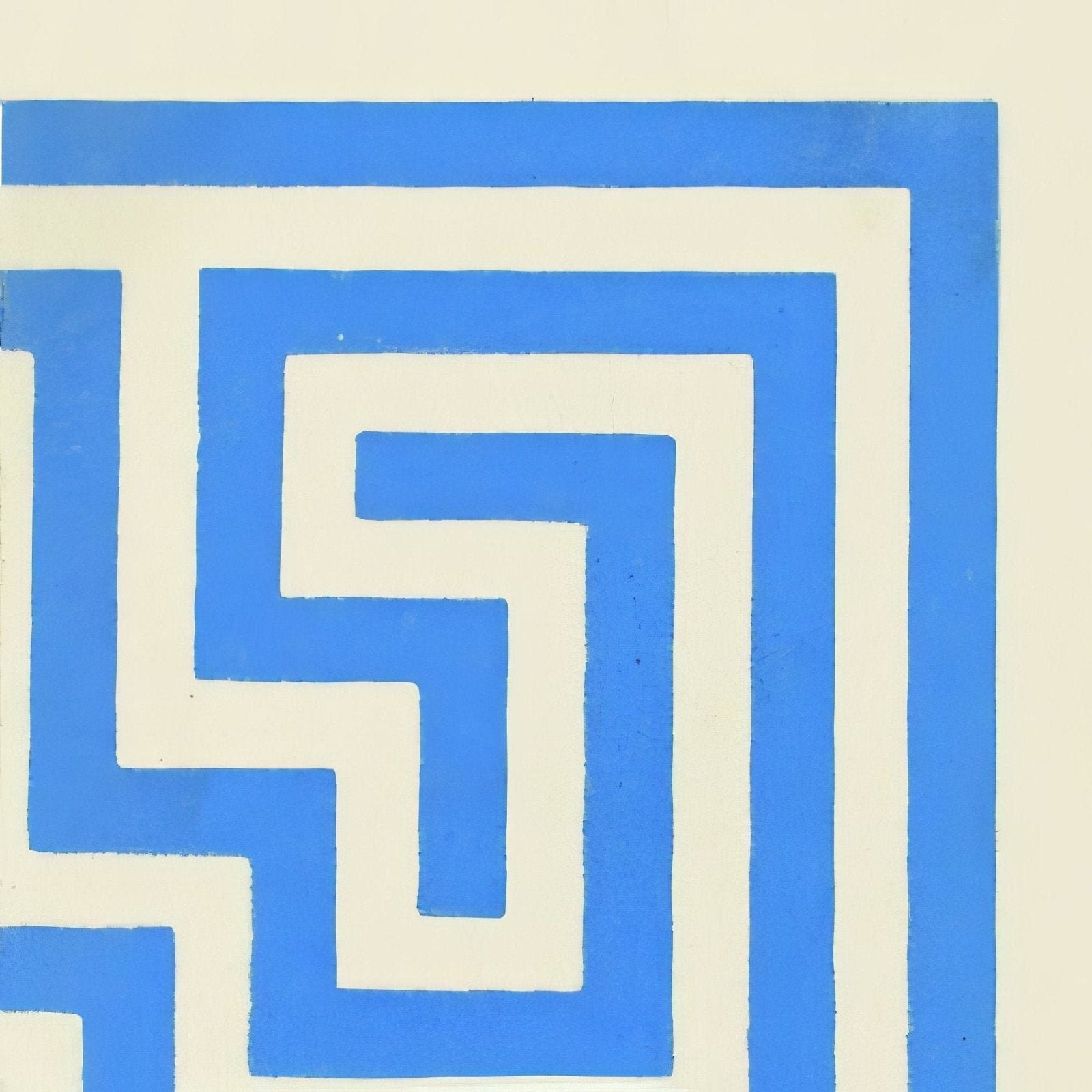 Blue and cream geometric patterned ceramic wall tile featuring greek key corner design on white background