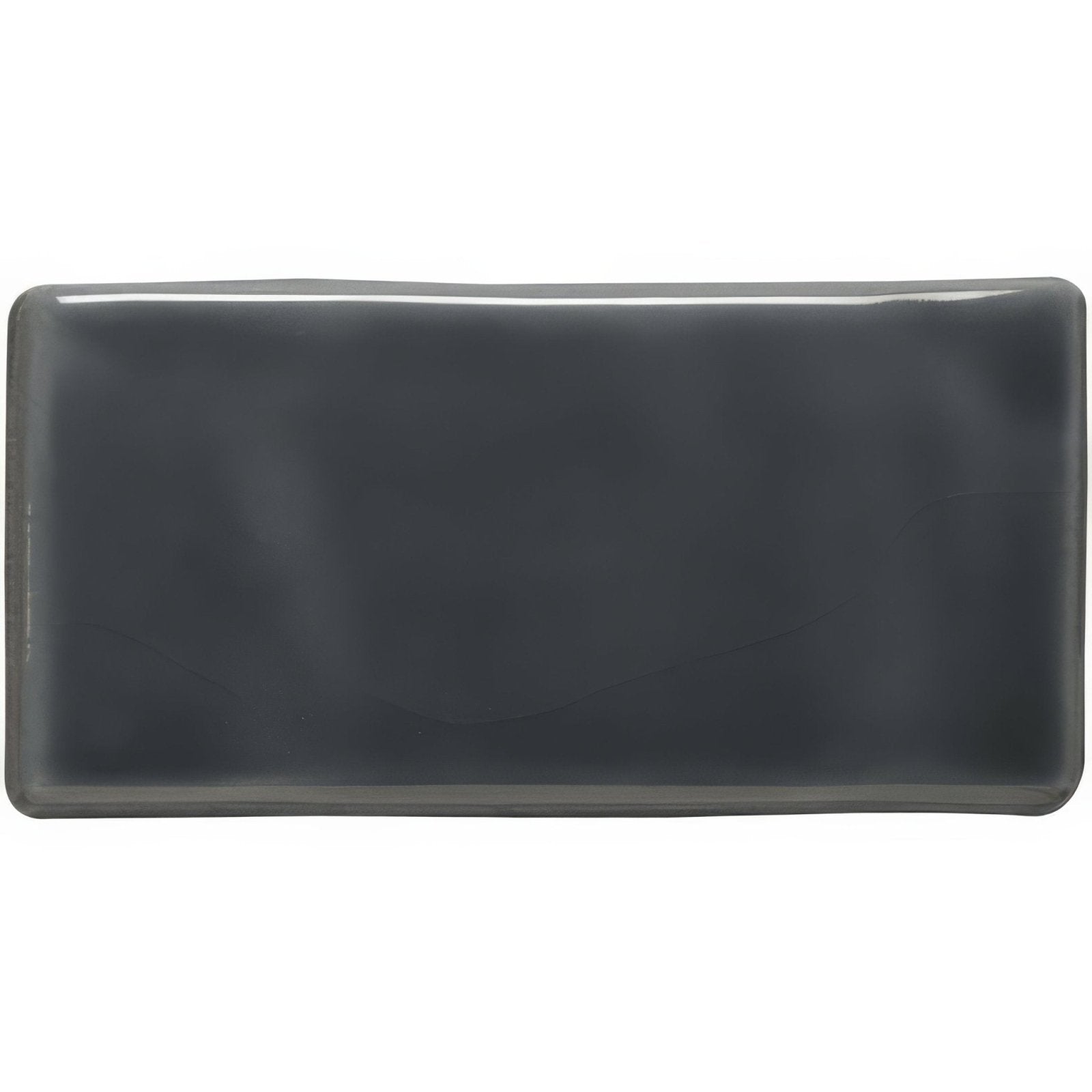 A sleek rectangular grey half tile made of ceramic with a glossy dark gray finish and softly rounded edges