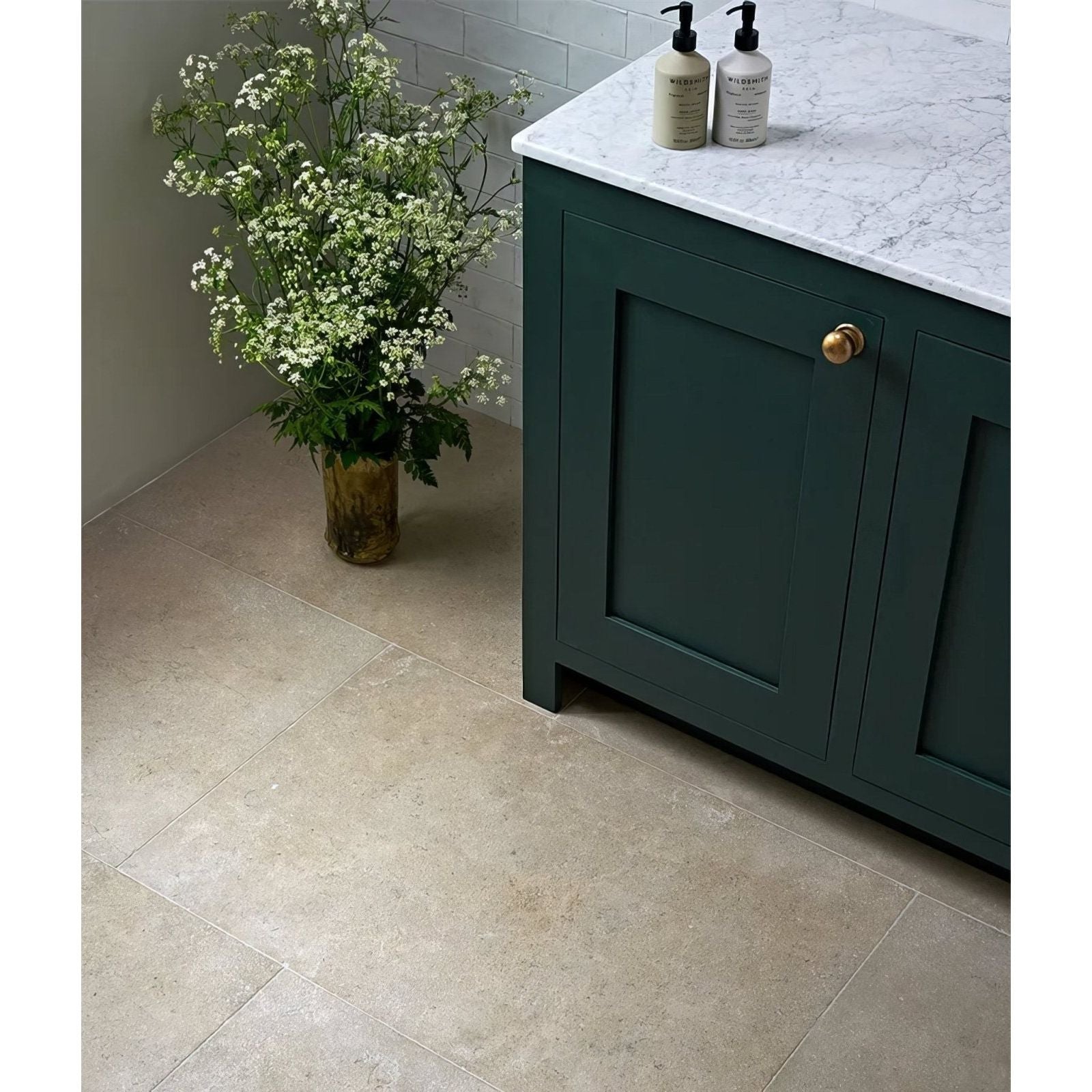 Dark green wychwood limestone velvet finish cabinet with gold-finished handle and marble countertop