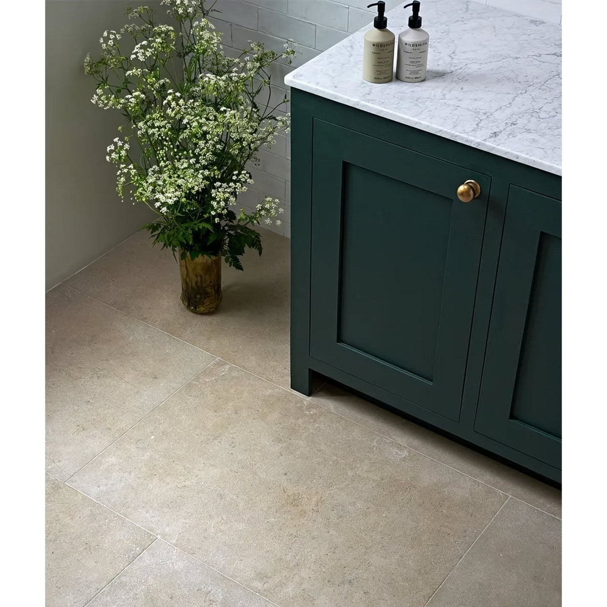 Dark green wychwood limestone velvet finish cabinet with gold-finished handle and marble countertop