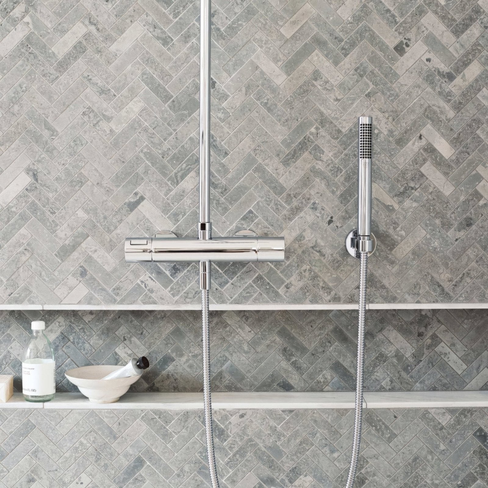 Hampton Bays Herringbone Mosaic grey stone herringbone mosaic with a chrome shower system
