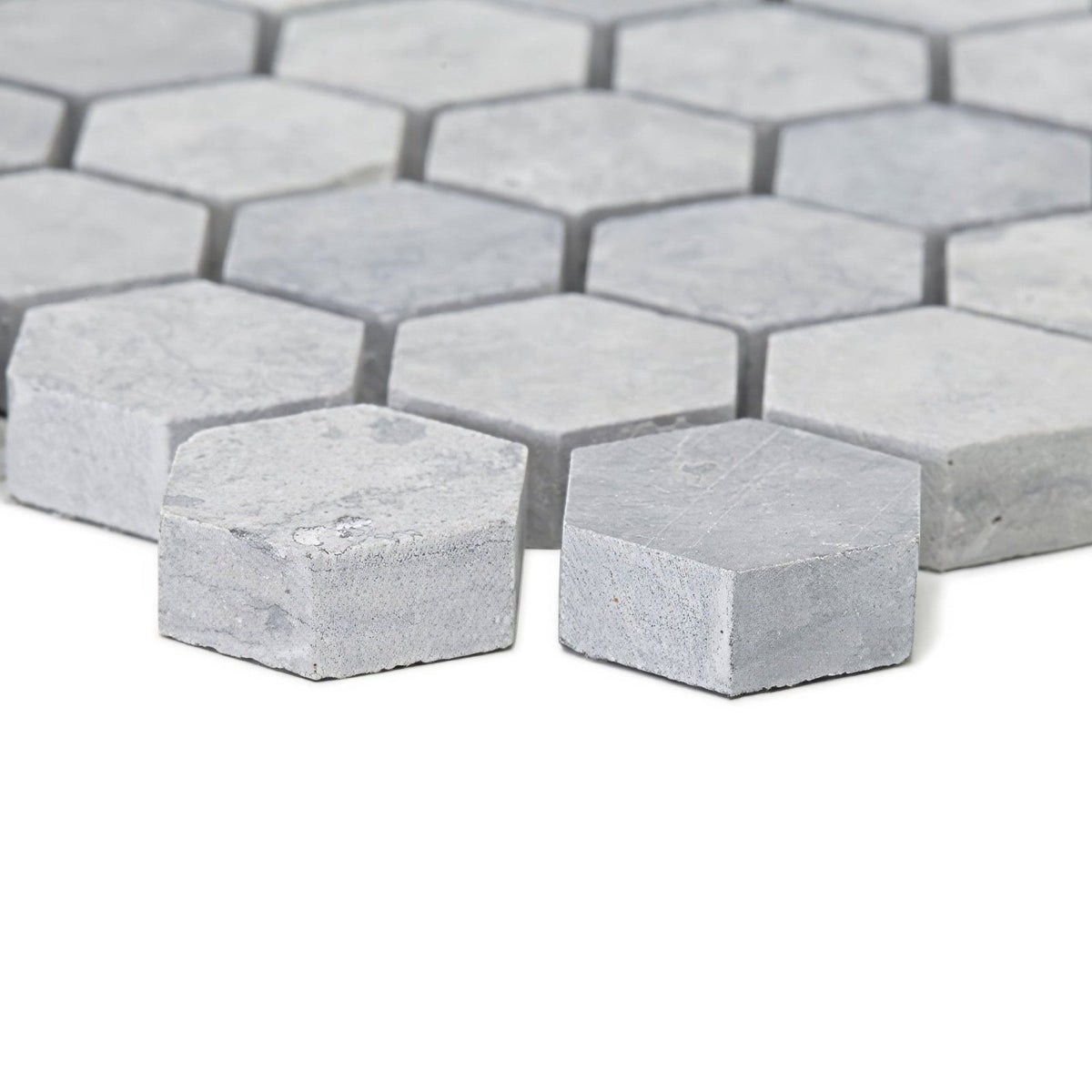 Light gray hexagonal marble mosaic tiles with subtle veining in the hampton bays hexagon mosaic design
