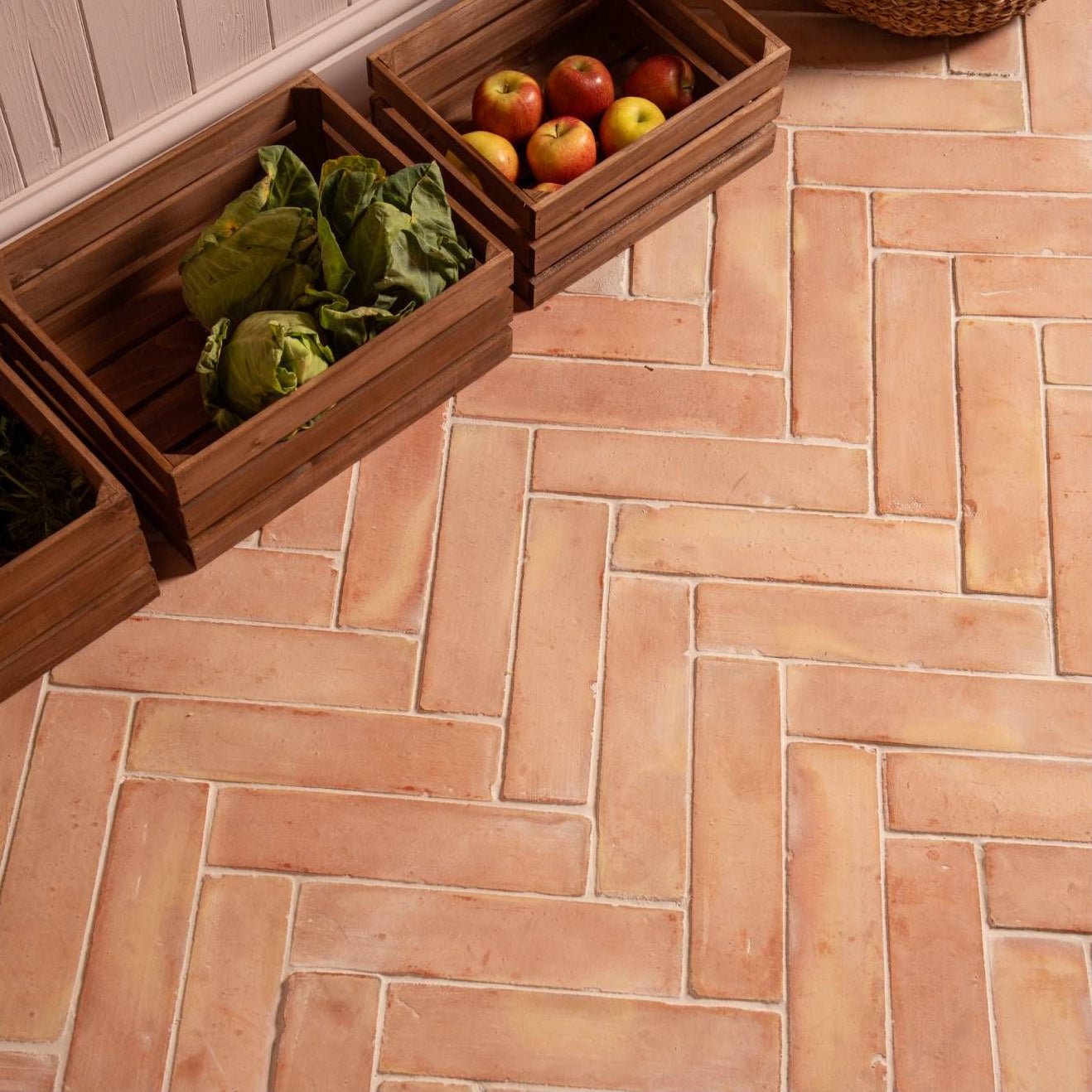Handmade terracotta square floor tiles with a herringbone pattern in 20 x 20cm size for stylish flooring