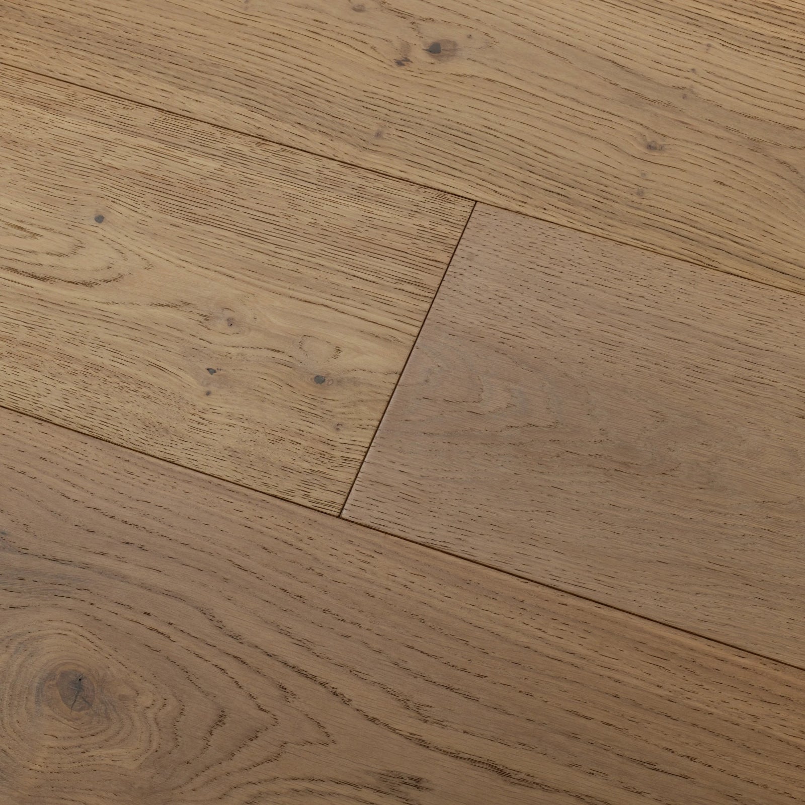 Light brown hardwood floor planks with natural wood grain and subtle knots harlech raw oak flooring