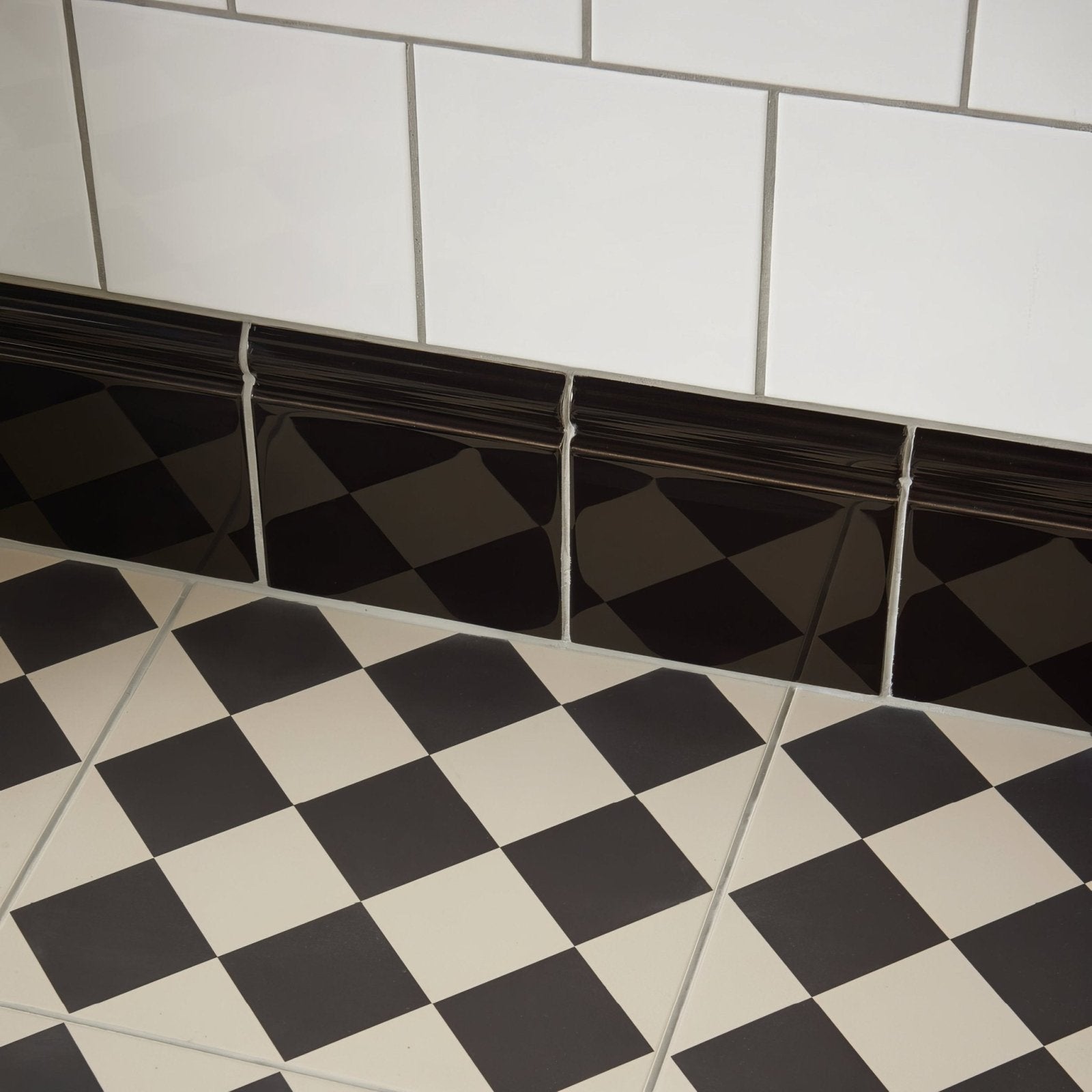Black glossy diamond patterned tile trim from harlequin large black on chalk collection for decorative edging