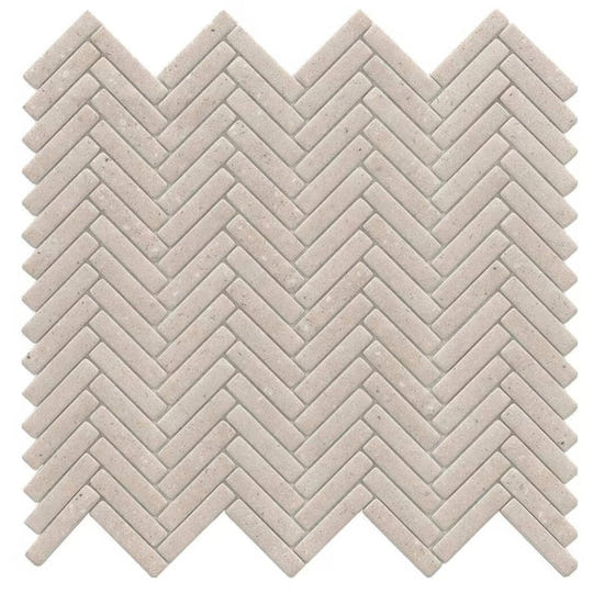 Beige stone mosaic tile with a herringbone pattern in the herringbone bottega caliza mosaic product