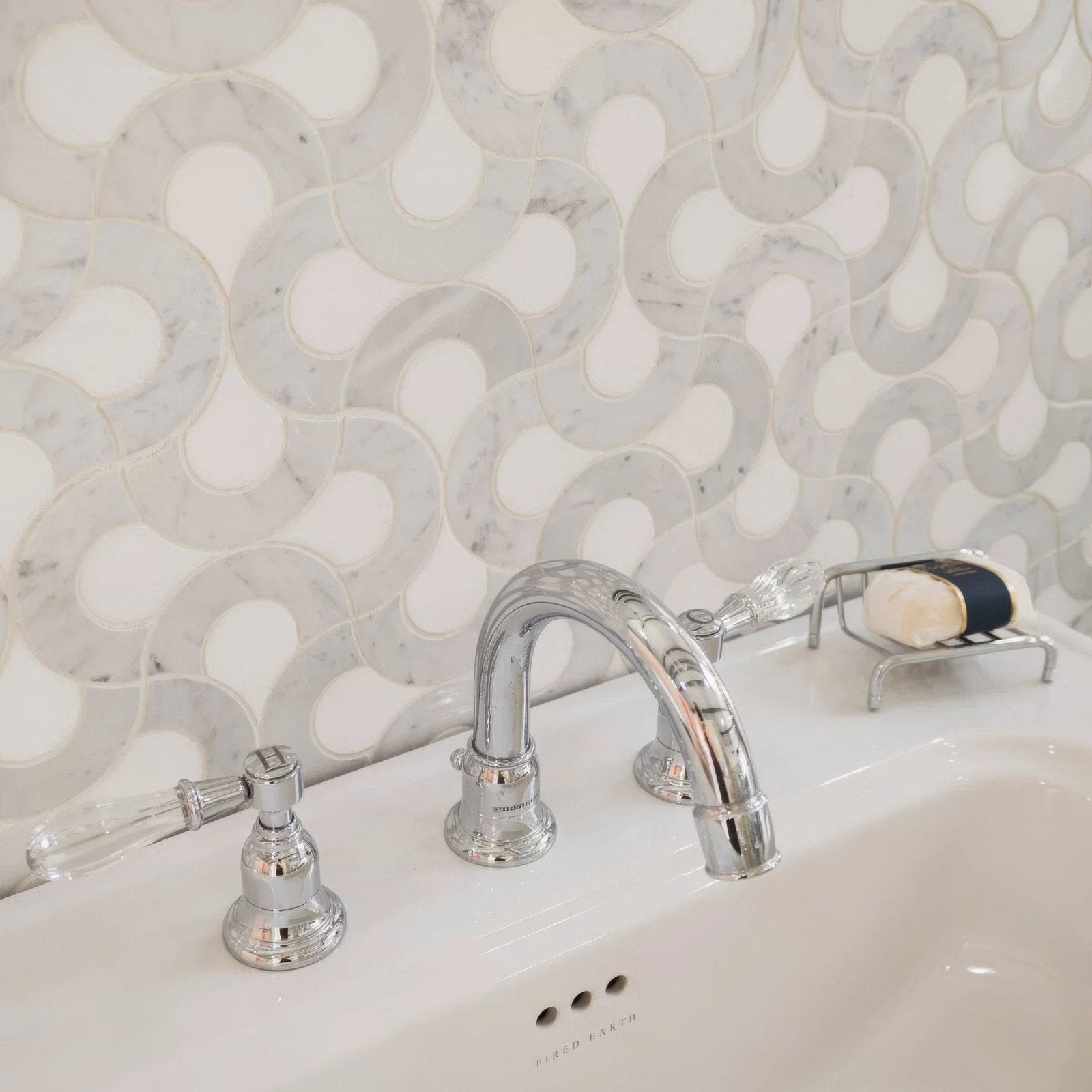 High Society Marble Guggenheim chrome three-handle bathroom faucet with clear crystal handles and white marble backsplash