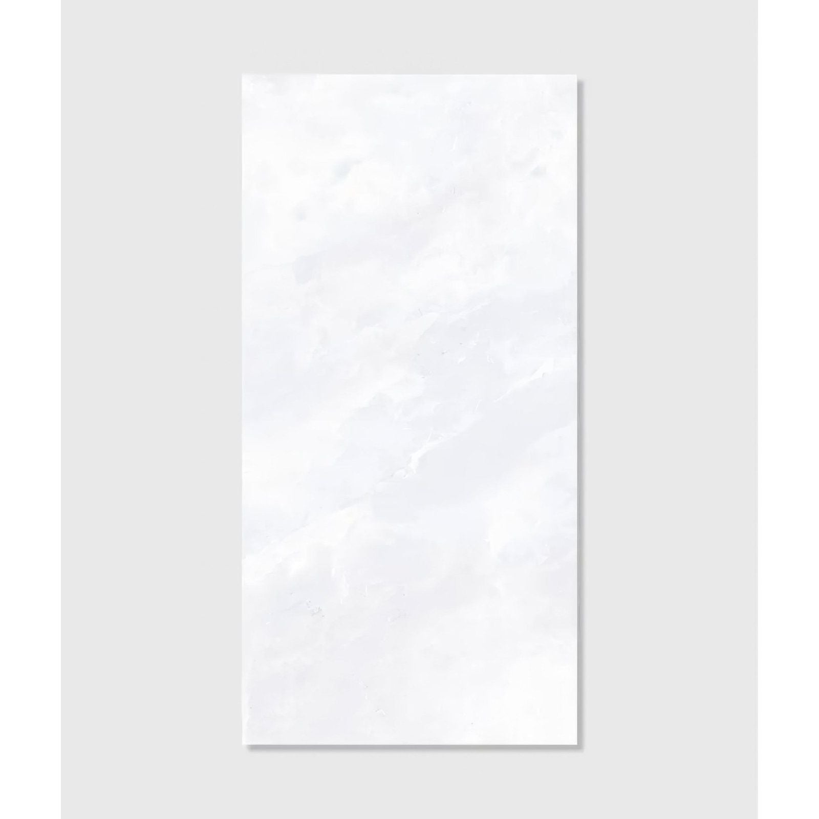 A sleek rectangular white marble Himalaya porcelain matt crystal tile with subtle veining and a glossy finish