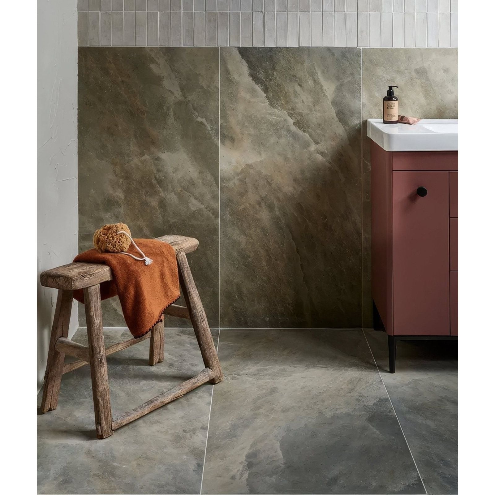 Himalaya Porcelain Matt Fjord beige marble-effect tiles with a wooden stool and orange towel
