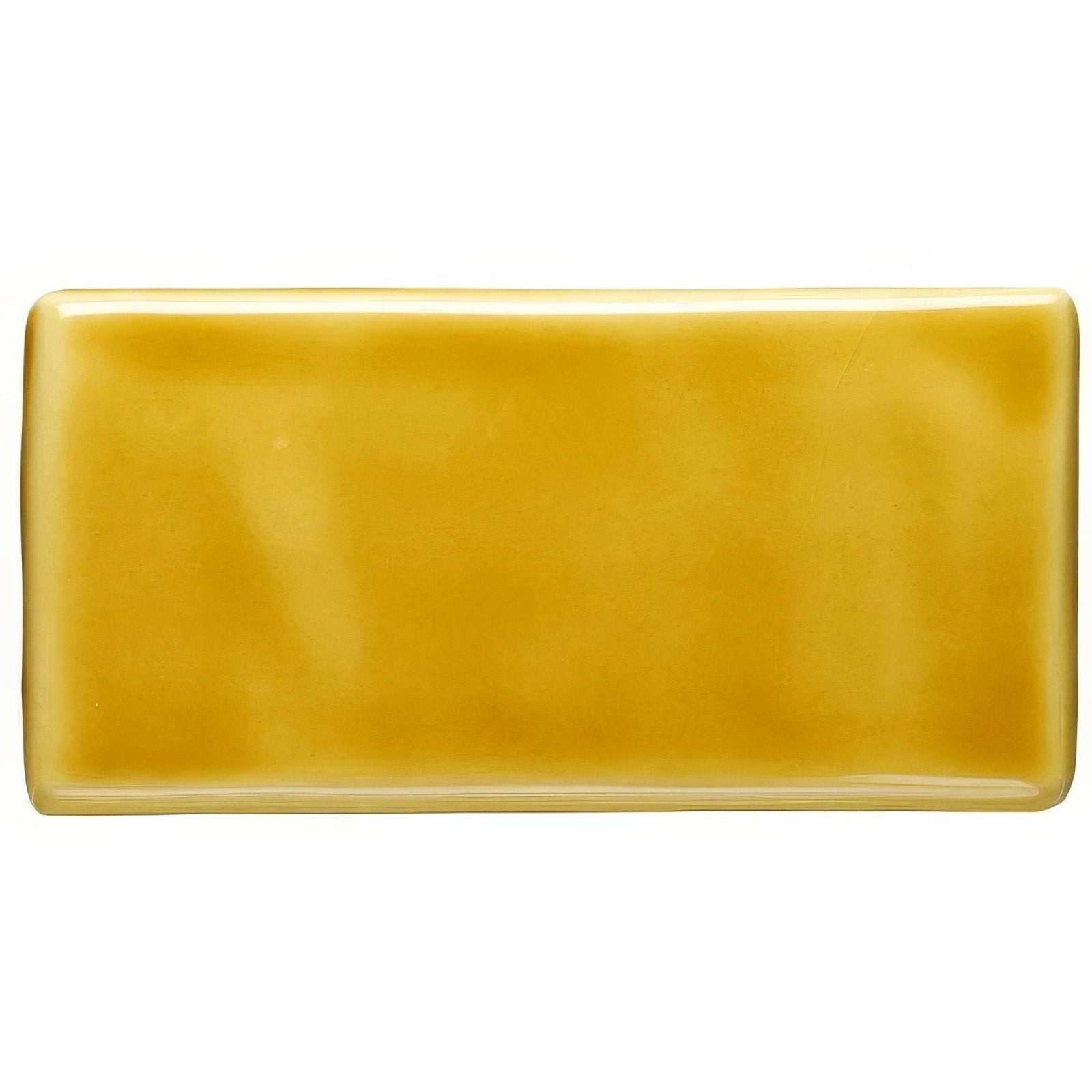 A smooth rectangular ceramic honey half tile with a glossy mustard yellow glaze for wall and floor use