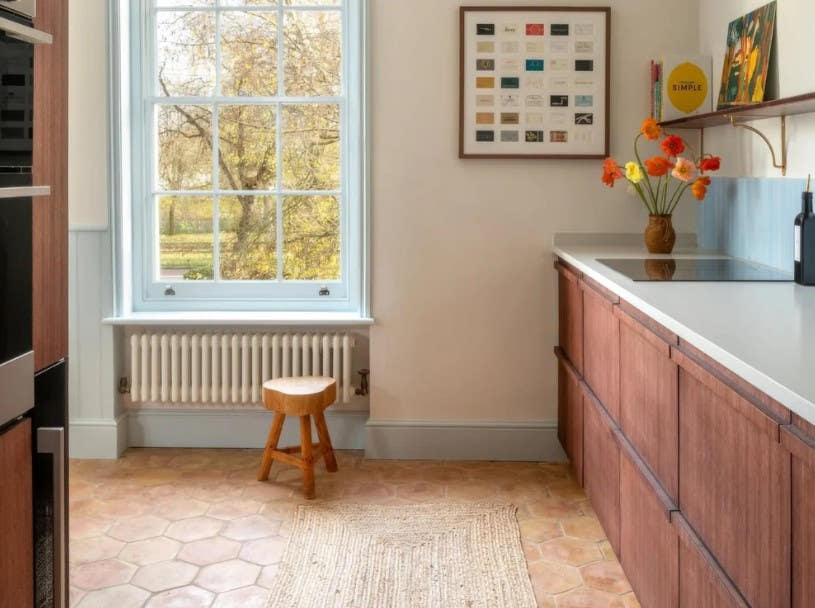 Kitchen with a terracotta hexagon floor beneath a sash window