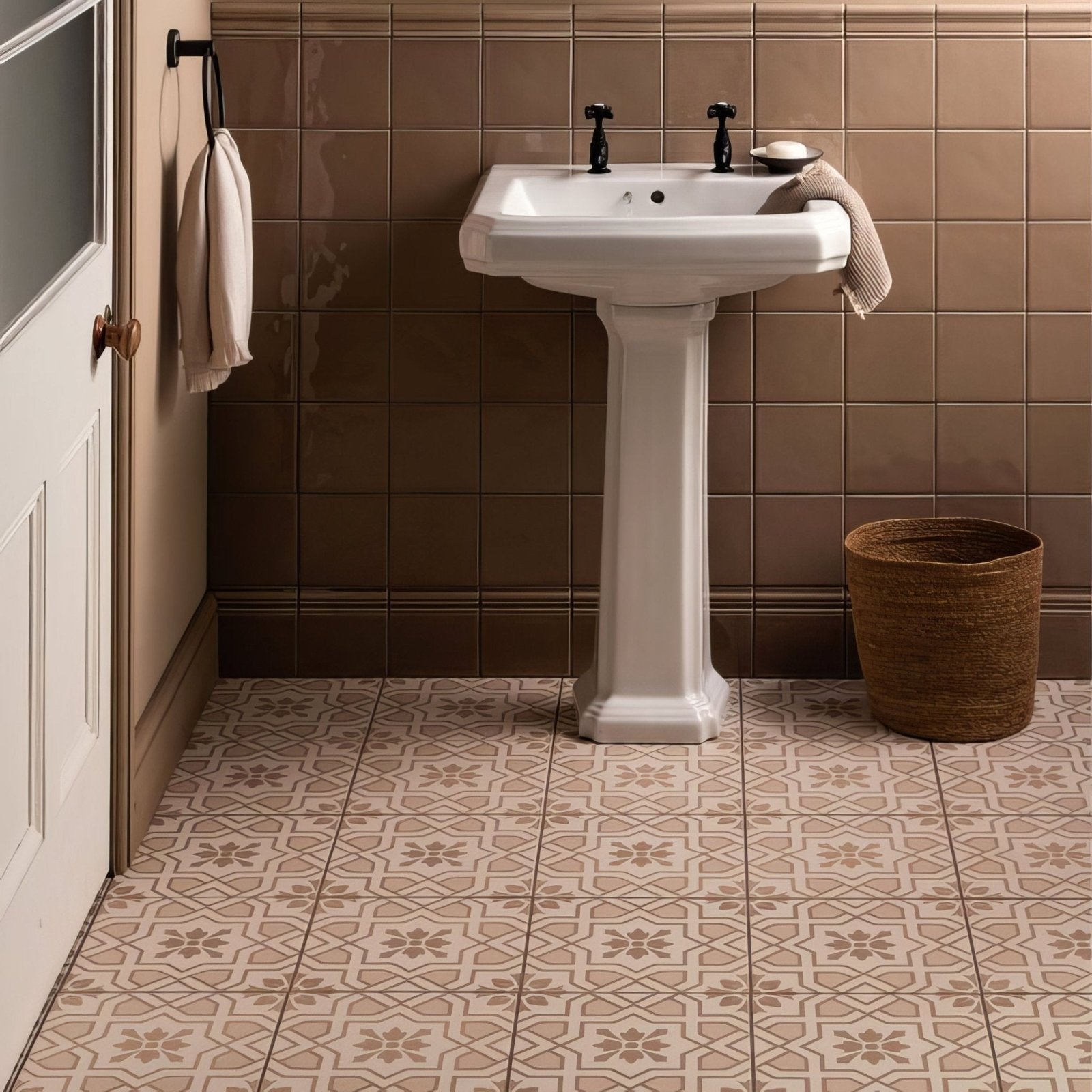 White ceramic pedestal sink with black faucet handles featured in ickworth field tile design