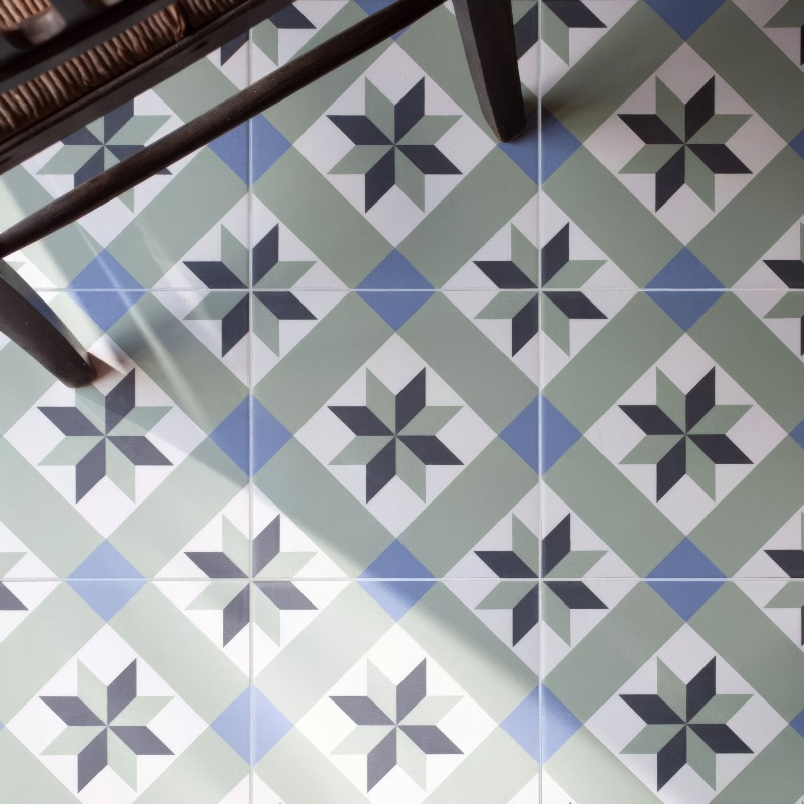 Infusion Ribeira patterned ceramic floor tiles with geometric star design in shades of gray blue and white