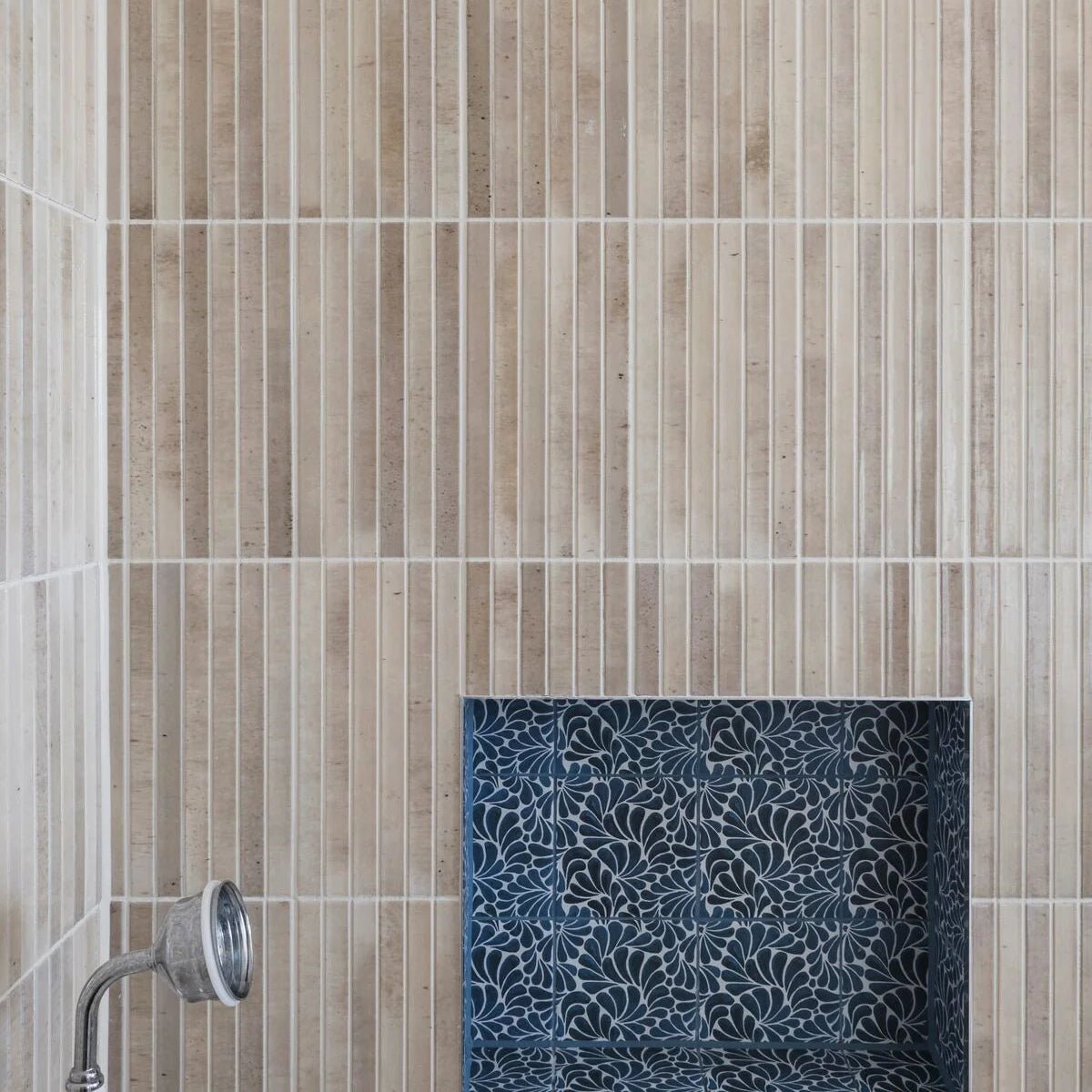 Beige ixworth ivory bar tile wall with vertical tiles and a blue floral mosaic inset feature