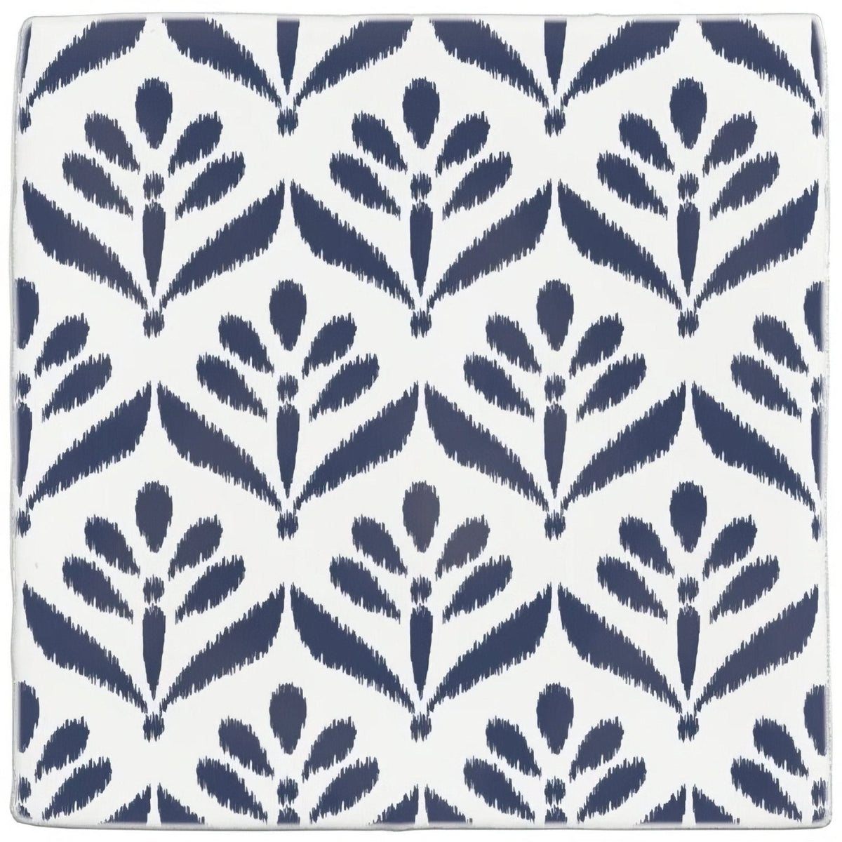 White ceramic coaster with repeating navy blue ikat-style floral pattern from jacquard indigo collection