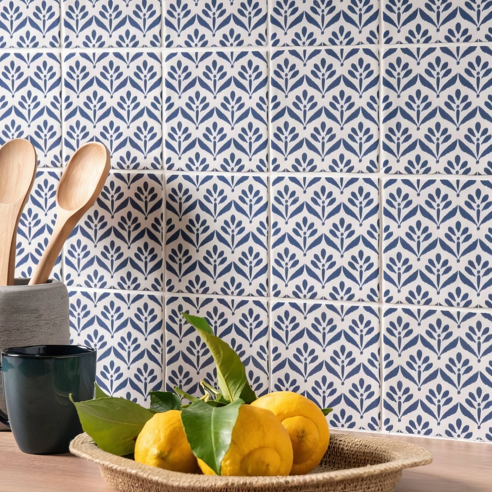 A woven jacquard indigo basket filled with bright yellow lemons and green leaves for decorative use
