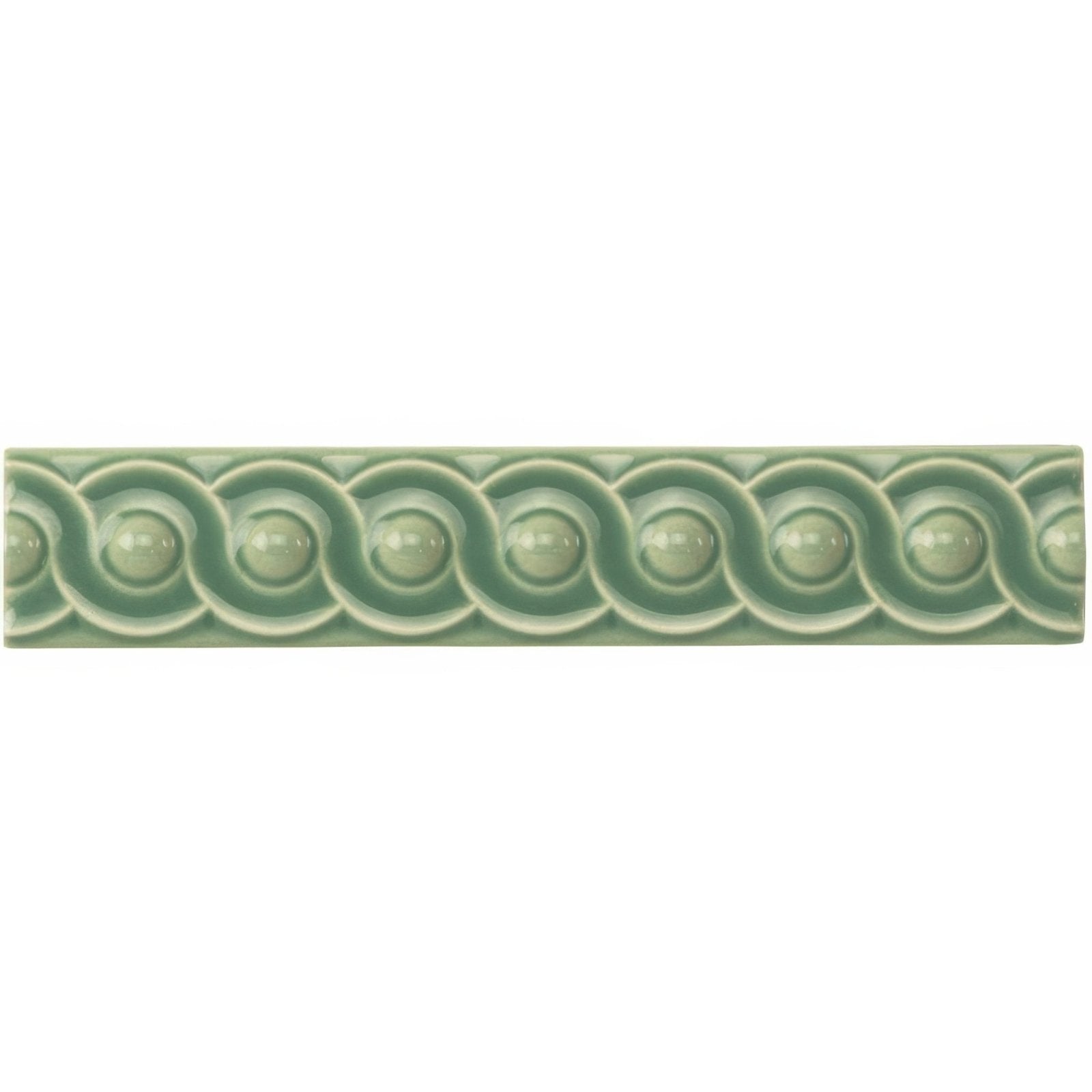 Jade breeze scroll moulding is a sage green ceramic tile with raised circular motifs in a rectangular shape