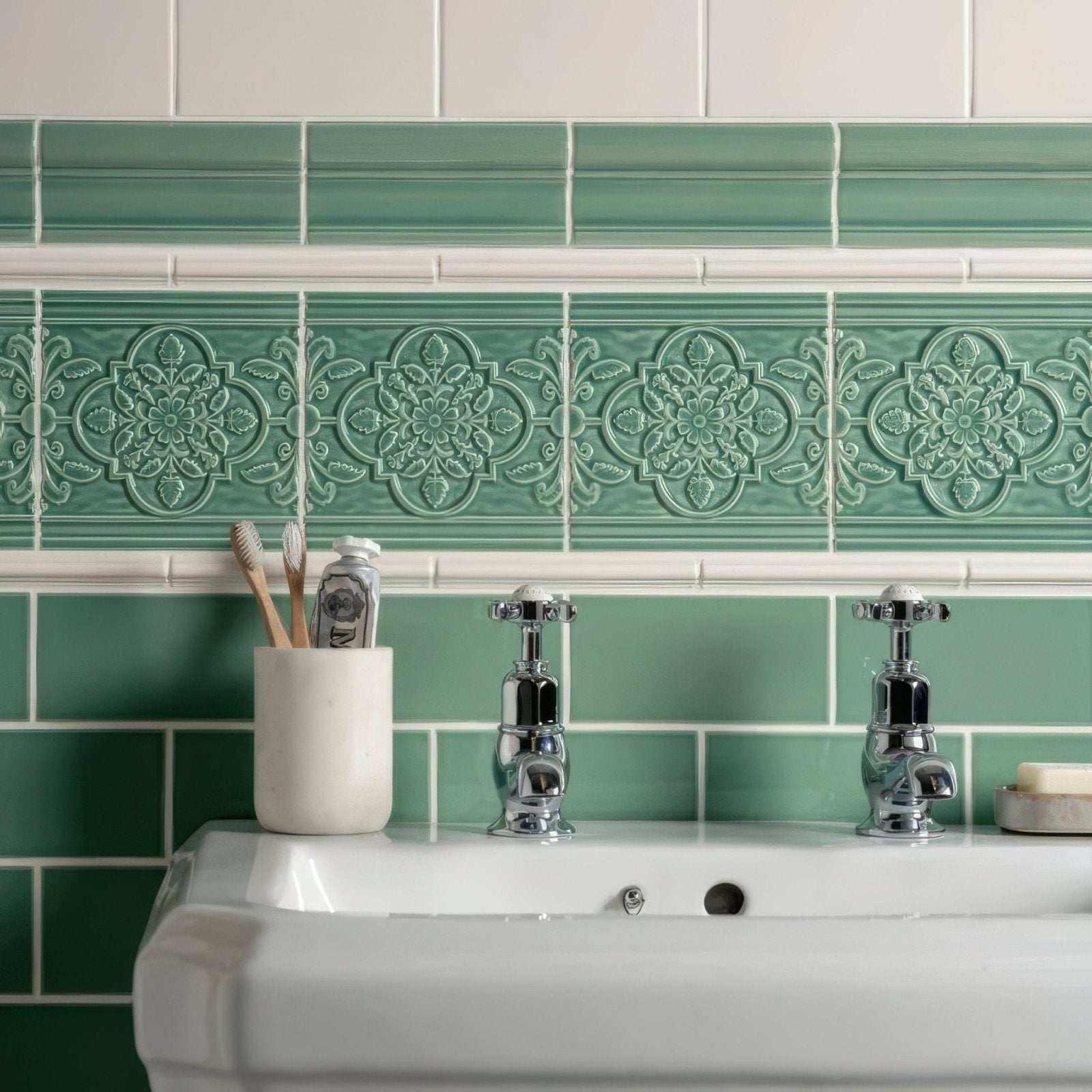 Emerald green ceramic jade breeze victoria moulding tiles with raised floral patterns used as decorative bathroom backsplash