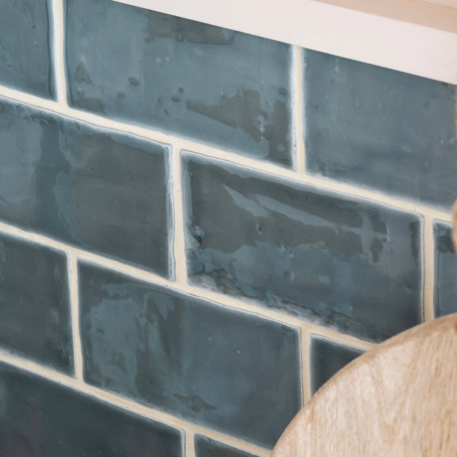 Dark blue rectangular ceramic tiles with a matte textured finish arranged in a classic brick pattern from Jaipur Dartmouth Green Rectangle Glazed Tile