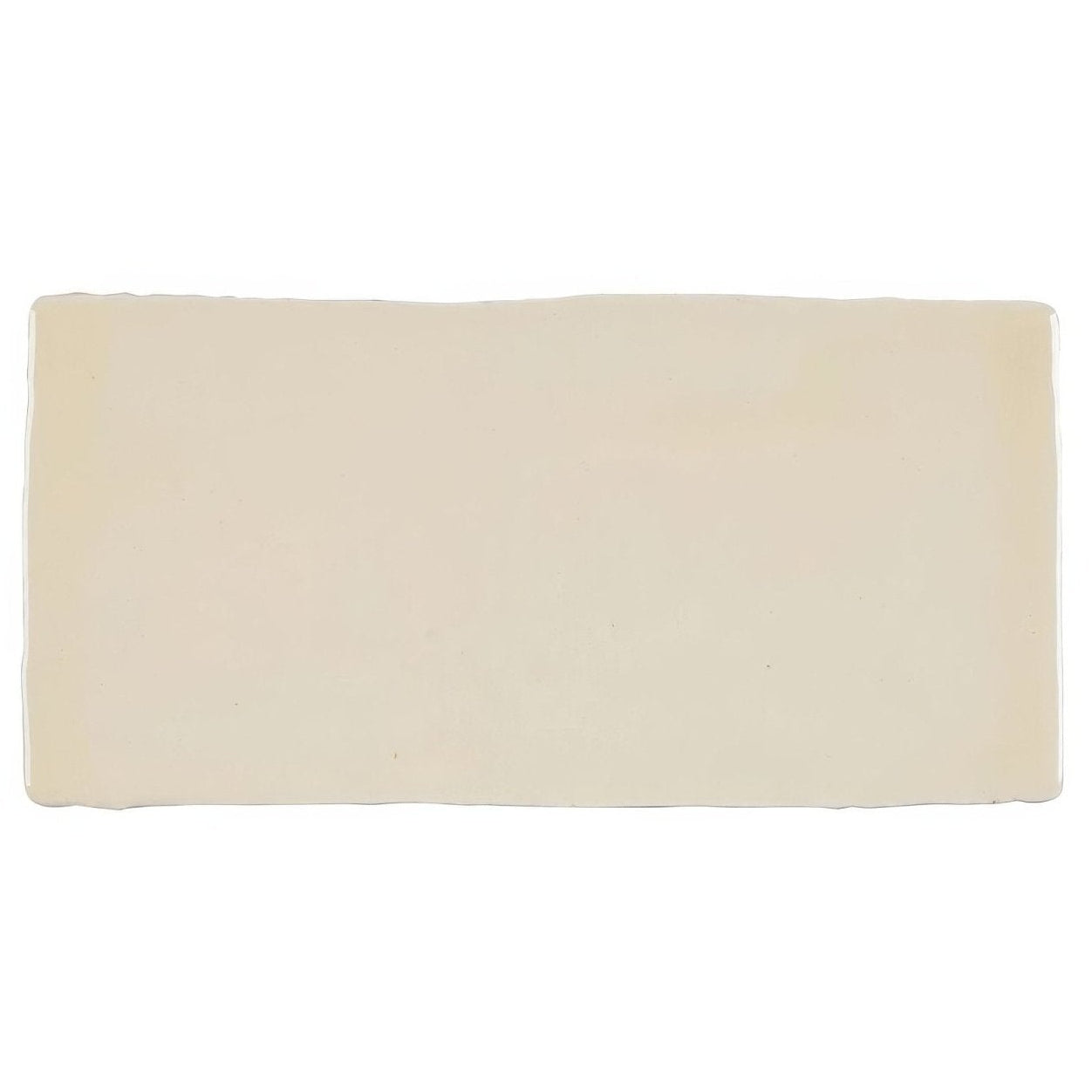 Cream-colored rectangular ceramic Jaipur Old Ochre rectangle glazed tile with slightly uneven rustic edges
