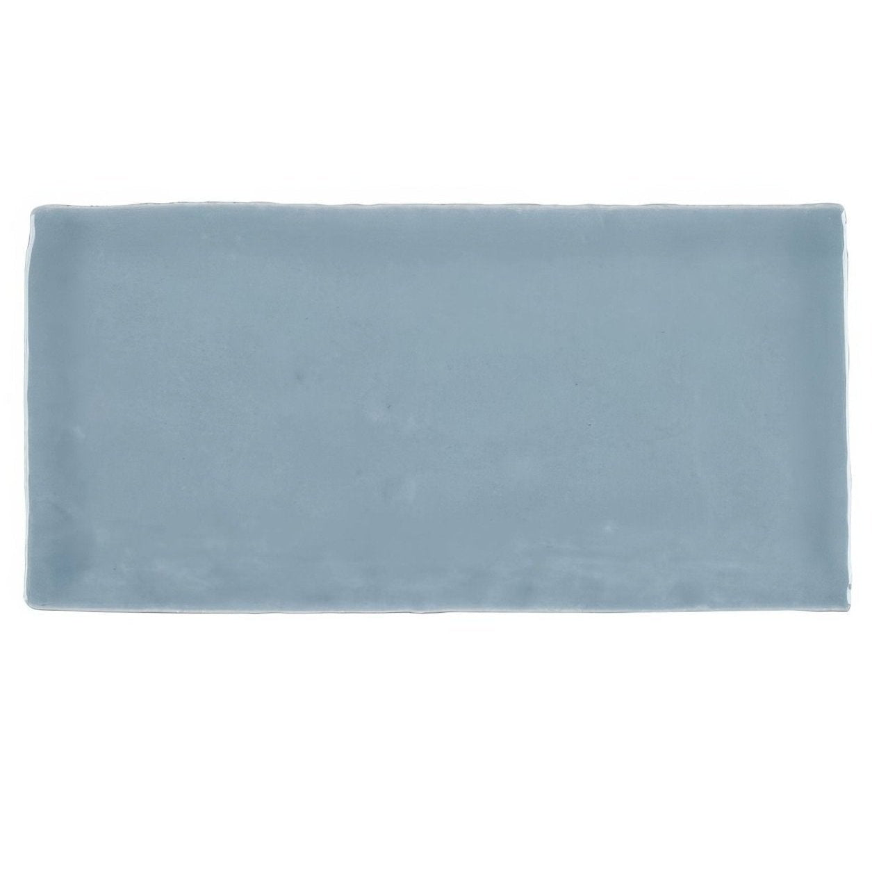 Jaipur storm rectangle glazed tile is a light blue matte ceramic tile with slightly uneven edges and a rectangular shape